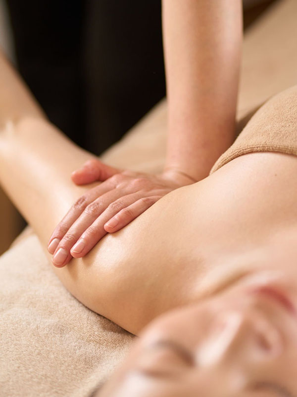 Woman receiving arm massage at beauty salon
